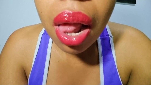 Latina with full lips paints them red and plays with her naughty tongue for you