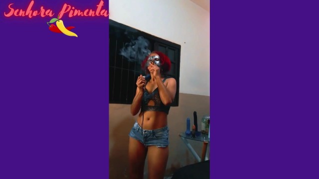 Senhora Pimenta does a Striptease while sensually smoking a cigar.