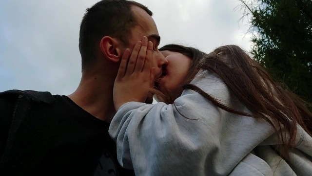 Kissing with beautiful girlfriend in the park